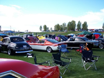 1972 Ford Ranchero - Several classic cars are on display at an outdoor event under a partly cloudy sky.