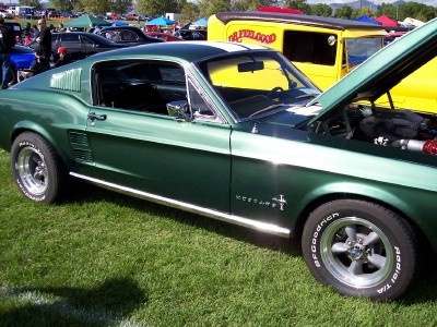 1972 Ford Ranchero - A green 1967 Ford Mustang fastback is displayed at an outdoor car show.