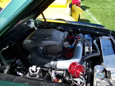 1972 Ford Ranchero - Custom engine bay modification with a prominent supercharger system and associated plumbing.