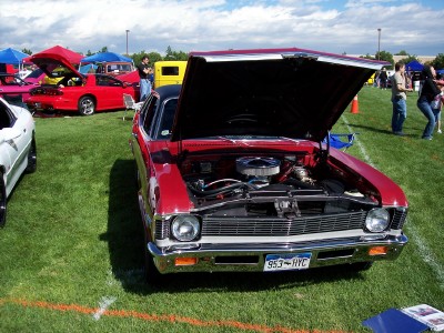 1972 Ford Ranchero - A red 1970 Chevrolet Nova is displayed with its hood up at an outdoor car show.
