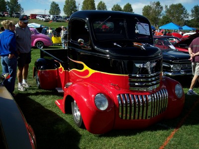 1972 Ford Ranchero - This customized vintage truck features a striking black and red paint scheme with flame graphics.