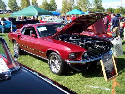 1972 Ford Ranchero - Red 1969 Ford Mustang Mach 1 on display at a car show, hood open to reveal the engine.