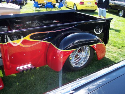 1972 Ford Ranchero - This customized pickup truck features a striking flame paint job and exposed engine components.