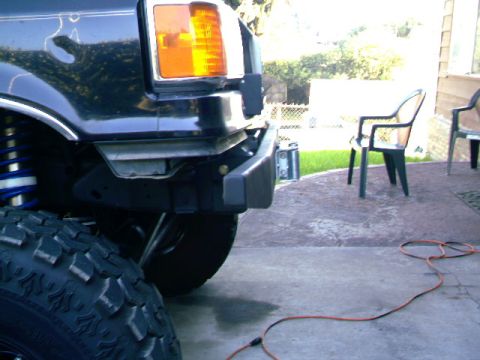 1989 Ford Bronco - Close-up of the front bumper and tire of a 1989 Ford Bronco.