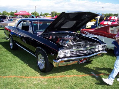 1972 Ford Ranchero - A black 1967 Chevrolet Chevelle SS is displayed with its hood open at an outdoor car show.