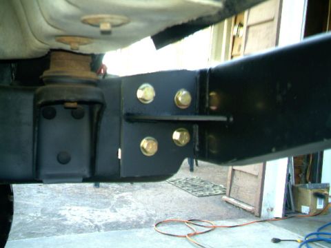 1989 Ford Bronco - Close-up view of vehicle frame and suspension components, with visible bolts and mounting brackets.
