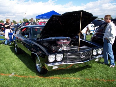 1972 Ford Ranchero - A black muscle car, likely a 1970 model, is displayed with its hood open at an outdoor car show.