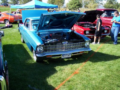 1972 Ford Ranchero - A bright blue coupe, likely a 1966 model, is displayed with its hood open at an outdoor car show.