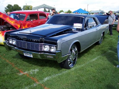 1972 Ford Ranchero - A two-tone silver and black 1968 Lincoln Continental Mark III is displayed at an outdoor car show.