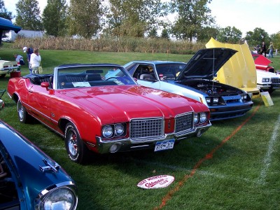 1972 Ford Ranchero - 1972 Oldsmobile Cutlass Supreme convertible at a car show.