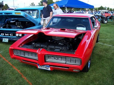 1972 Ford Ranchero - A red 1969 Pontiac GTO is displayed with its hood open at an outdoor car show.