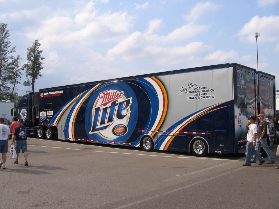 Miller Lite semi-truck transporter with racing graphics and text about championships