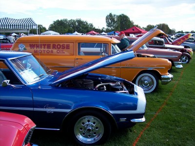 1972 Ford Ranchero - A blue 1968 Chevrolet Camaro SS is displayed with its hood open at an outdoor car show.