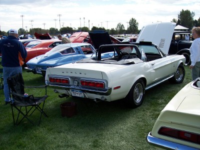 1972 Ford Ranchero - A white 1968 Shelby convertible is displayed at an outdoor car show with other vehicles and attendees.