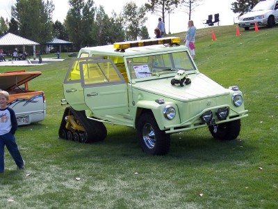 1972 Ford Ranchero - Modified Volkswagen Thing with tracks on the rear axle displayed on a grassy field.