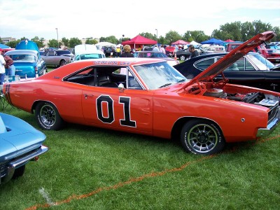 1972 Ford Ranchero - A classic orange Dodge Charger, famously known as the General Lee, is displayed with its hood open at an outdoor car show.