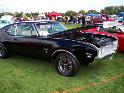 1972 Ford Ranchero - A black 1970 Oldsmobile 442 W-31 is displayed with its hood open at an outdoor car show.