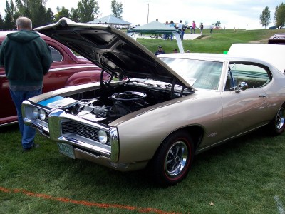1972 Ford Ranchero - A classic Pontiac GTO is displayed with its hood open at an outdoor event.
