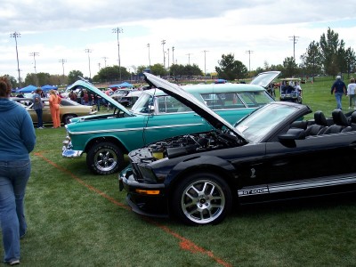 1972 Ford Ranchero - Multiple vehicles with hoods open are displayed on a grassy field at an outdoor event.
