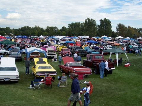 1972 Ford Ranchero - A large gathering of vehicles are on display at an outdoor event, with spectators milling around.