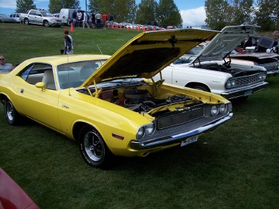 1972 Ford Ranchero - A yellow 1970 Dodge Challenger is displayed with its hood open at an outdoor car show.