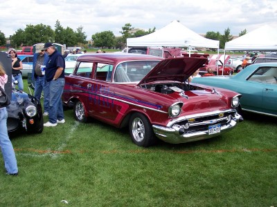 1972 Ford Ranchero - A classic 1957 Chevrolet Nomad station wagon is displayed with its hood open at an outdoor car show.