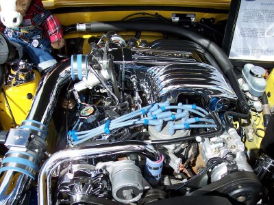 1972 Ford Ranchero - A close-up view of a modified engine bay, chrome components and a stuffed toy.