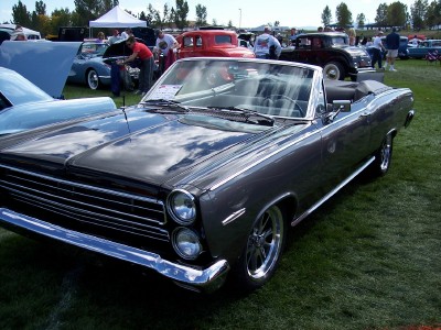 1972 Ford Ranchero - A dark gray 1967 Mercury Cougar convertible is displayed at an outdoor car show.