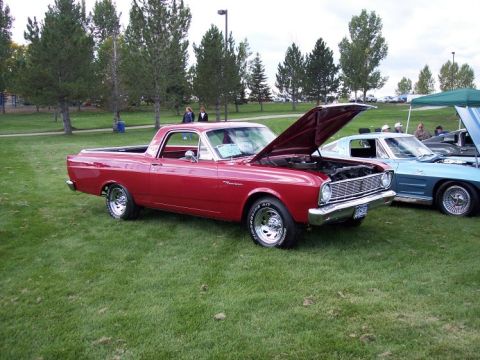 1972 Ford Ranchero - A red 1968 Ford Ranchero is displayed with its hood open at an outdoor car show.