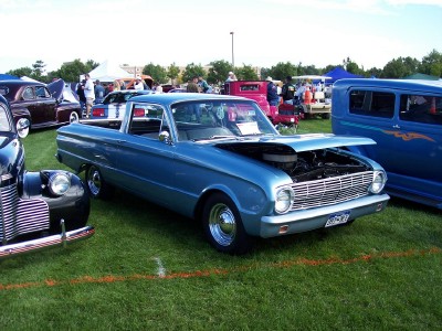 1972 Ford Ranchero - A blue 1960 Ford Falcon Ranchero is displayed with its hood up at an outdoor car show.