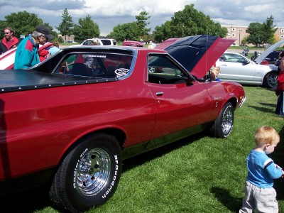 1972 Ford Ranchero - A red 1972 Ford Ranchero is displayed with its hood open at an outdoor car show.