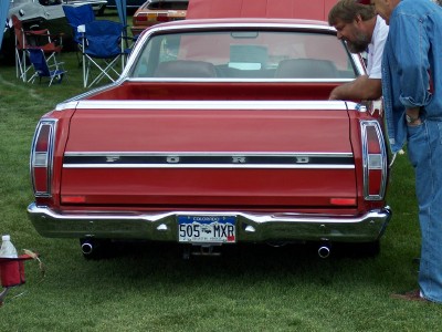 1972 Ford Ranchero - The rear of a red 1972 Ford Ranchero shows its distinctive tailgate with 'FORD' lettering and chrome bumper.