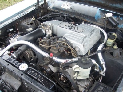 1972 Ford Ranchero - Close-up view of a car's engine bay, showing the intake manifold, hoses, and belts.