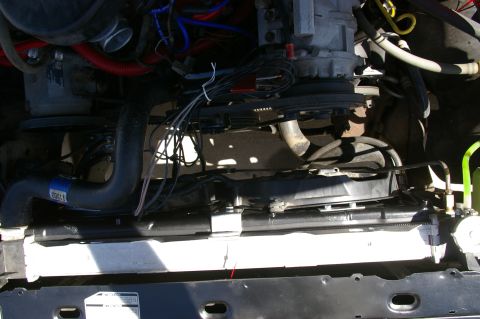 1986 Ford Bronco - Close-up view of the engine compartment, focusing on the cooling system components and associated wiring.