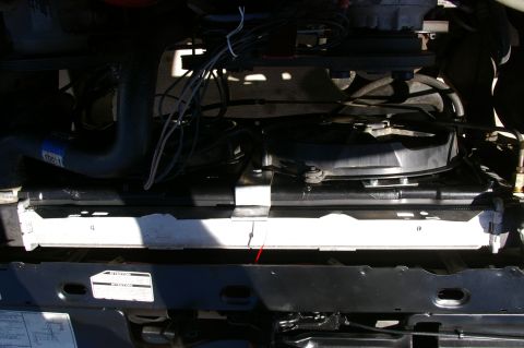 1986 Ford Bronco - Close-up view of the electric fan and radiator assembly, showing hoses and wiring.