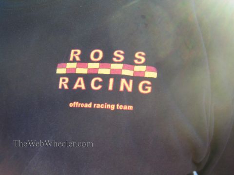1990 Ford Bronco - dark T-shirt is printed with a checkered red-and-yellow logo reading ROSS RACING offroad racing team.