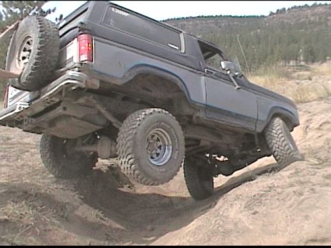 1985 Ford Bronco - This 1985 Ford Bronco is navigating rough terrain off-road.