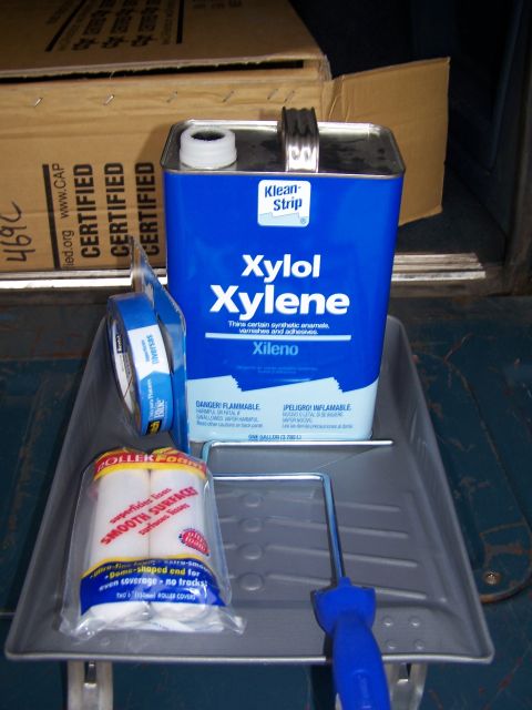 1986 Ford Bronco - Painting supplies staged in a metal roller tray: a one-gallon can of Klean-Strip Xylol xylene thinner, a roll of blue painter's tape, and a…