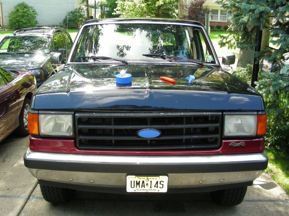 Front view of dark blue and maroon Ford Bronco with blue Ford grille emblem and NJ plate UMA-14S