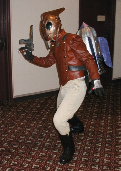 1991 Ford Bronco - Steampunk cosplayer with a ray gun and jetpack poses indoors.