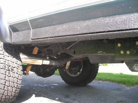 1994 Ford Bronco - The underside of a vehicle is captured, highlighting the exhaust system and rear axle components.