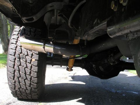 1994 Ford Bronco - Close-up view of the undercarriage, focusing on the exhaust system and rear axle.