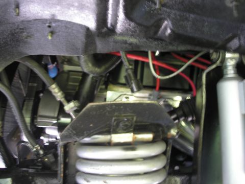 1994 Ford Bronco - Close-up view of vehicle suspension and engine components, including springs and wiring.
