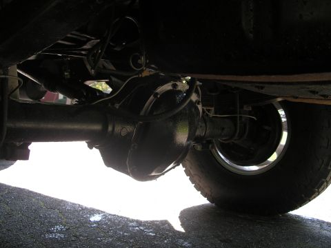 1994 Ford Bronco - Underside view of a vehicle's rear axle and suspension components.