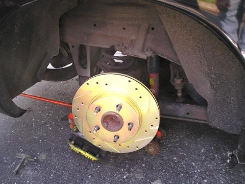 1994 Pontiac Trans Am - Close-up of a car's brake system with a new rotor installed.