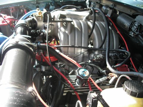 1994 Ford Bronco - Close-up view of a vehicle's engine compartment, showing the intake manifold and associated components.