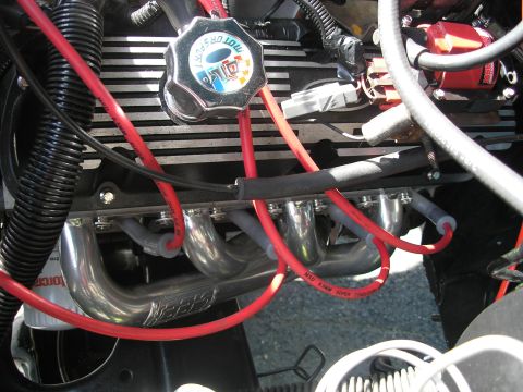 1994 Ford Bronco - Close-up of an engine bay chrome headers and red spark plug wires, suggesting performance upgrades.