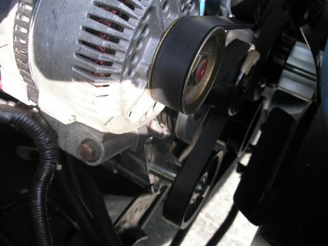 1994 Ford Bronco - The alternator and serpentine belt system are visible in this close-up engine shot.
