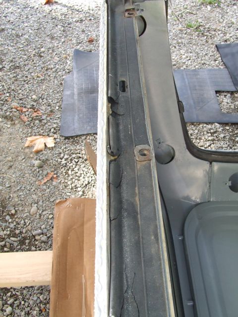 1979 Ford Bronco - Close-up of a vehicle's interior door frame, showing a deteriorated seal and a watermark for SuperMotors.net.