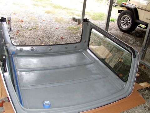 1979 Ford Bronco - Removed Ford Bronco hardtop interior, with a Jeep in the background.